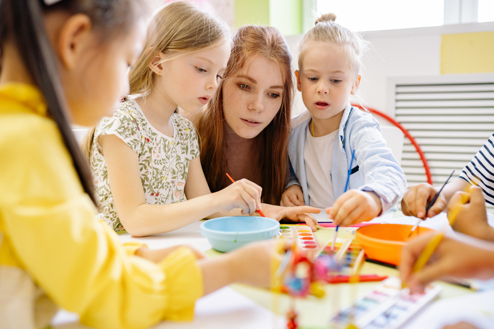 kids colouring in with carer